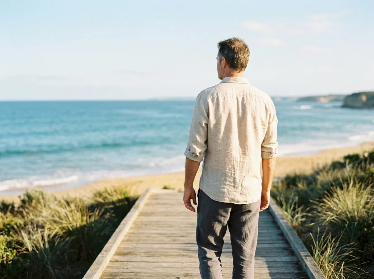 Anonymous man looking at ocean horizon - food supplement for active ageing men